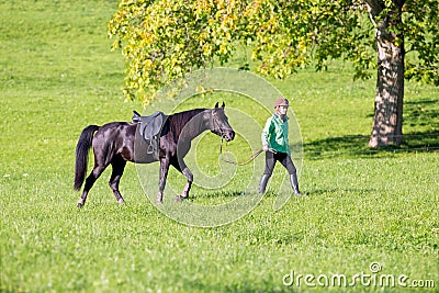 Woman walking with horse