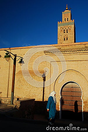 Woman walking near Koutoubia Mosque. Marrakech, Morocco