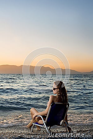 Woman watching sunset on the beach