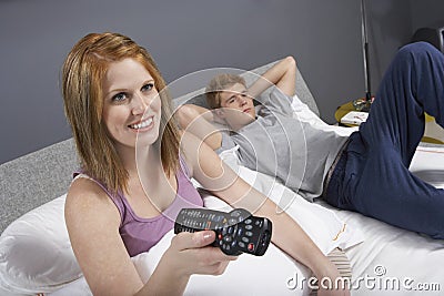 Woman Watching TV In Bed