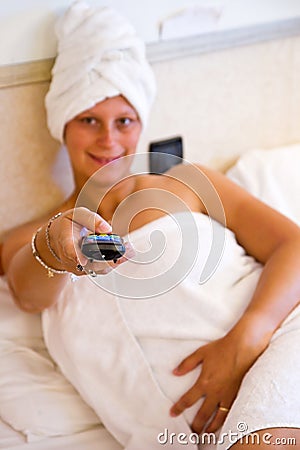 Woman watching TV on her bed