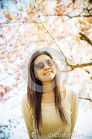 Woman wear eyeglass with pink cherry flower tree