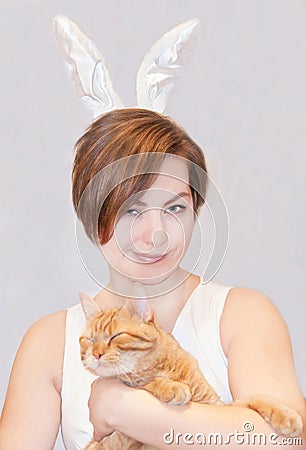 Woman, wearing easter bunny ears, with a cat.