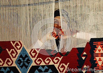 Woman weaving a traditional Turkish carpet