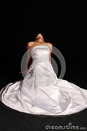 Woman in wedding dress on her knees