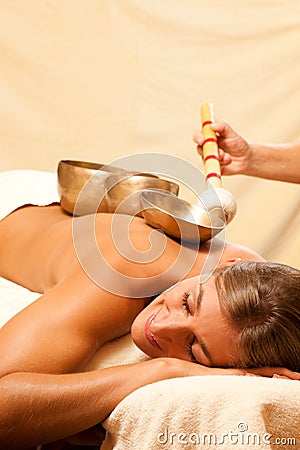 Woman and Wellness with singing bowls