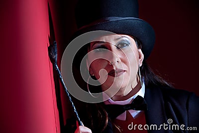 Woman with whip wearing a top hat