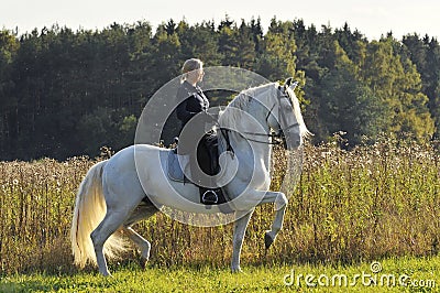 Woman on white horse