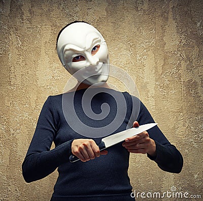 Woman in white mask holding the knife