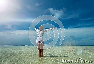 Woman with wide open arms standing