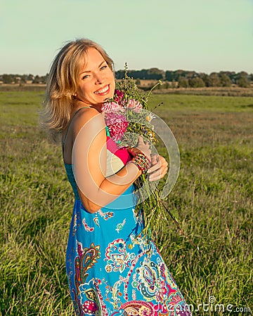 Woman with wild flowers smiling