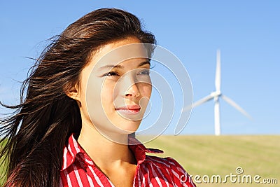 Woman by wind turbine