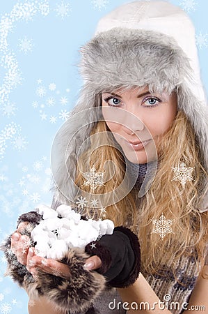 Woman in winter hat and gloves with snowflakes