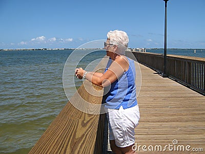 Woman on wooden pier over water