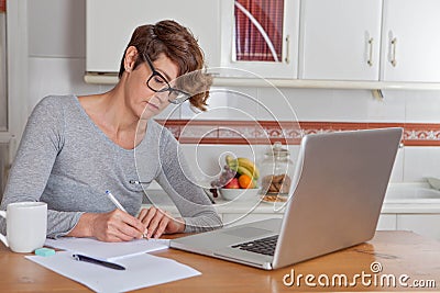 Woman working or blogging in home office.