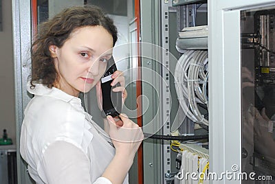 Woman working on telecommunication equipment