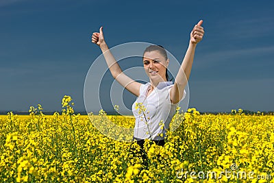 Woman in the yellow flower field show best gesture
