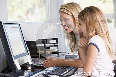 Woman and young girl in office with computer