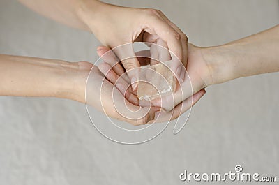 Womans hands giving a quartz crystal one to another