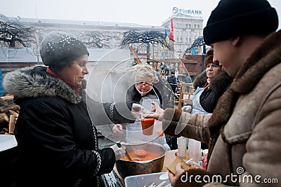 Women cook traditional borsch outdoor