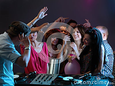 Women flirting with dj in night club