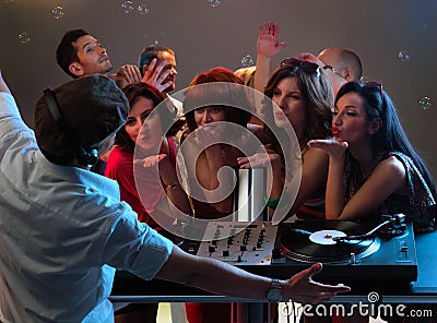 Women flirting with dj in night club