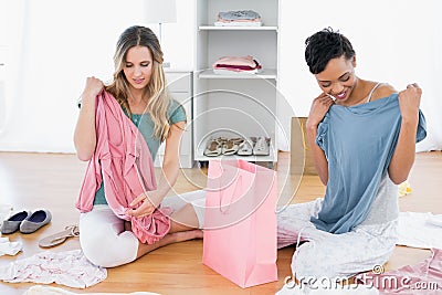 Women on floor with clothes and shopping bag