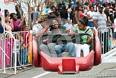 Women Laugh While Riding Carnival Ride