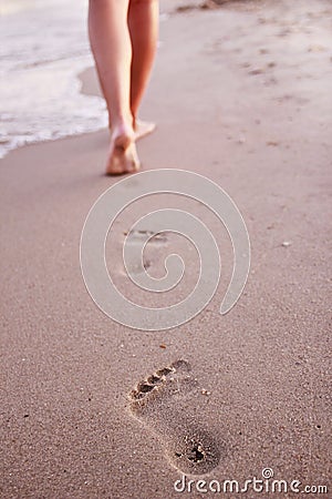 Women s footprints in the sand