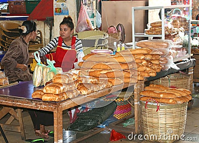 Women sells original fresh French baguettes, Laos