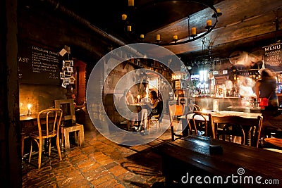 Women talking inside the old style bar with vintage furniture