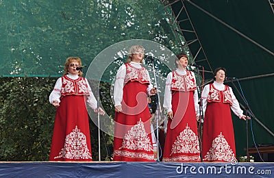 Women(woman)s in national suit sing on scene