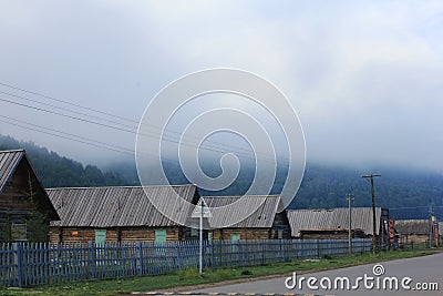 Wood cabins in the fog