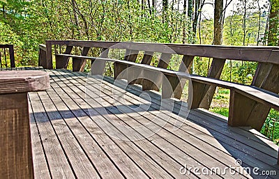 wooden deck on a house with a long bench seating area. Design style 