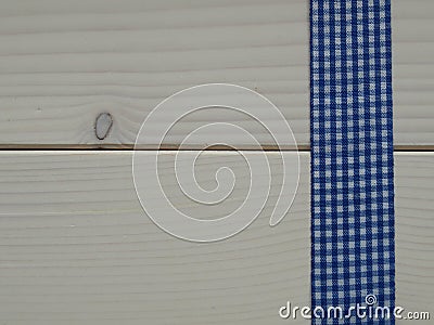 Wooden background with a checked ribbon