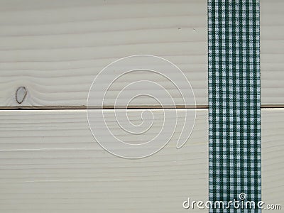 Wooden background with a checked ribbon
