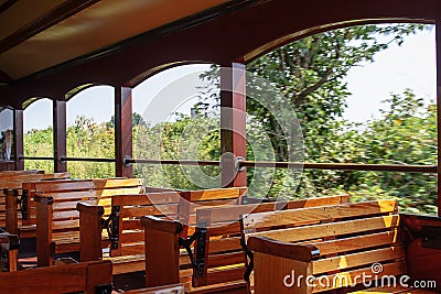 Wooden benches inside a vintage steam train