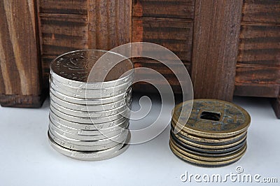 Wooden container with new and aged coins