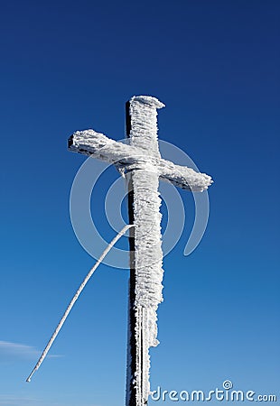 Wooden cross under snow