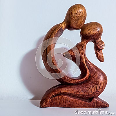 Wooden figure of a couple kissing