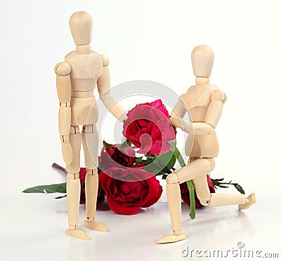 Wooden figurine man holding and giving rose to lover with rose b