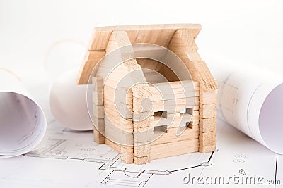Wooden house and blueprints