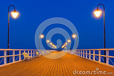 Wooden pier on Baltic Sea at night