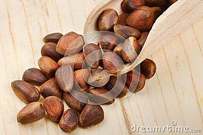 Wooden scoop with pine nuts