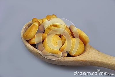 Wooden spoon full of crackers