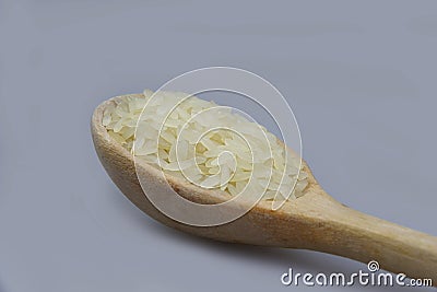 Wooden spoon full of white rice