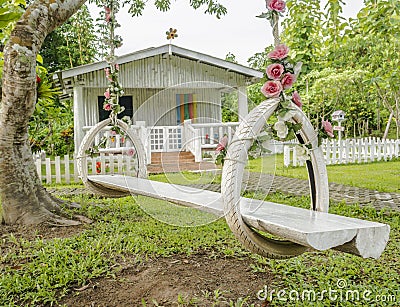 A wooden swing at the park