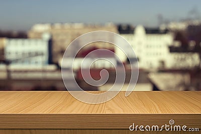 Wooden table over outdoor city blur background