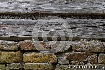 Wooden wall with a stone foundation