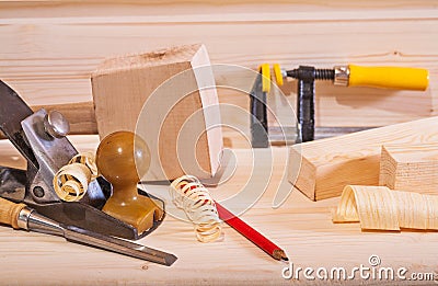 Woodworking plane with other tools on wooden board